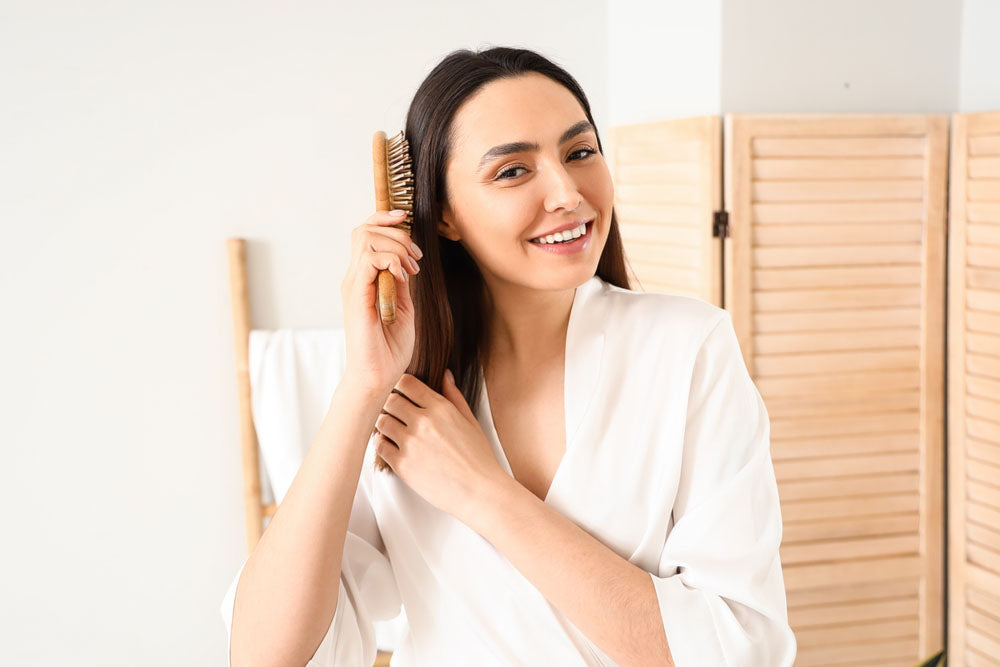 brushing hair in bathroom