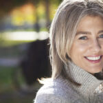 mature woman smiling at camera outside